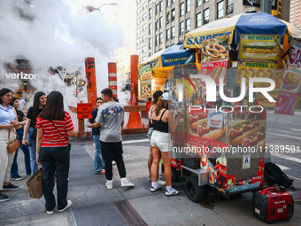 Sabrett Hot Dogs push-cart and steam vents in Manhattan, New York, United States of America, on July 6th, 2024.
 (