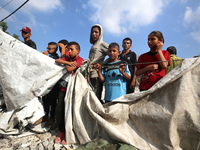 Palestinians are assessing the damage following an Israeli strike in Al-Zawayda in the central Gaza Strip on July 7, 2024, amid the ongoing...