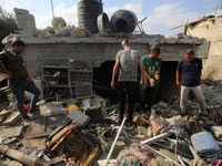 Palestinians are assessing the damage following an Israeli strike in Al-Zawayda in the central Gaza Strip on July 7, 2024, amid the ongoing...