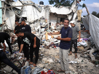 Palestinians are assessing the damage following an Israeli strike in Al-Zawayda in the central Gaza Strip on July 7, 2024, amid the ongoing...