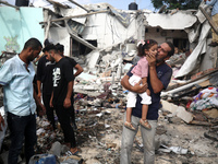 Palestinians are assessing the damage following an Israeli strike in Al-Zawayda in the central Gaza Strip on July 7, 2024, amid the ongoing...