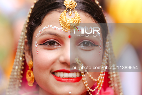 Nepali devotees are decorating as Radha and participating in the chariot of Lord Jagannath procession in Kathmandu, Nepal, on July 7, 2024. 