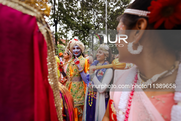 Nepali devotees are decorating as Lord Krishna and Radha and participating in the chariot of Lord Jagannath procession in Kathmandu, Nepal,...