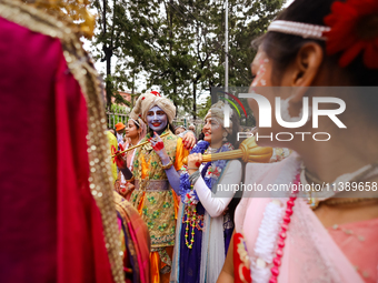 Nepali devotees are decorating as Lord Krishna and Radha and participating in the chariot of Lord Jagannath procession in Kathmandu, Nepal,...