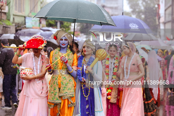 Nepali devotees are decorating as Lord Krishna and Radha and participating in the chariot of Lord Jagannath procession in Kathmandu, Nepal,...