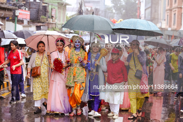 Nepali devotees are decorating as Lord Krishna and Radha and participating in the chariot of Lord Jagannath procession in Kathmandu, Nepal,...