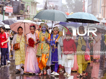 Nepali devotees are decorating as Lord Krishna and Radha and participating in the chariot of Lord Jagannath procession in Kathmandu, Nepal,...