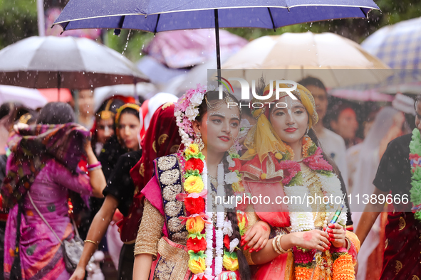 Nepali devotees are decorating as Lord Krishna and Radha and participating in the chariot of Lord Jagannath procession in Kathmandu, Nepal,...