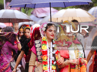 Nepali devotees are decorating as Lord Krishna and Radha and participating in the chariot of Lord Jagannath procession in Kathmandu, Nepal,...