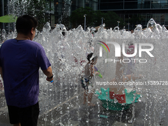 Kids are playing in water and keeping cool in Shanghai, China, on July 7, 2024. (