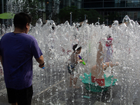 Kids are playing in water and keeping cool in Shanghai, China, on July 7, 2024. (