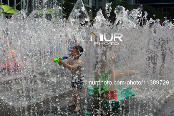 Kids are playing in water and keeping cool in Shanghai, China, on July 7, 2024. 