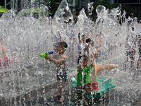 Kids are playing in water and keeping cool in Shanghai, China, on July 7, 2024. (