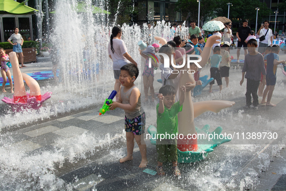 Kids are playing in water and keeping cool in Shanghai, China, on July 7, 2024. 