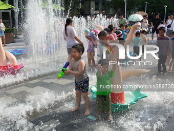 Kids are playing in water and keeping cool in Shanghai, China, on July 7, 2024. (