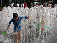 Kids are playing in water and keeping cool in Shanghai, China, on July 7, 2024. (