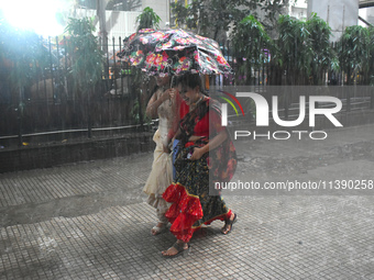 Women are passing during heavy rain in Kolkata, India, on July 7, 2024. (