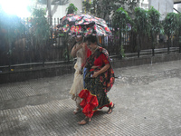 Women are passing during heavy rain in Kolkata, India, on July 7, 2024. (