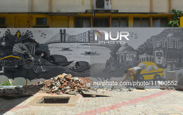 A person is working inside a constructed petrol pump in Kolkata, India, on July 7, 2024. 