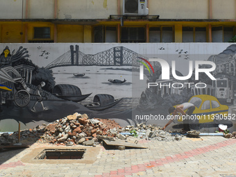 A person is working inside a constructed petrol pump in Kolkata, India, on July 7, 2024. (