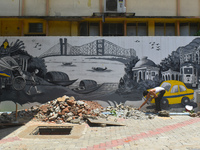 A person is working inside a constructed petrol pump in Kolkata, India, on July 7, 2024. (