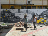 Laborers are working inside a constructed petrol pump in Kolkata, India, on July 7, 2024. (