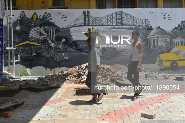 Laborers are working inside a constructed petrol pump in Kolkata, India, on July 7, 2024. 