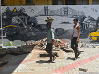 Laborers are working inside a constructed petrol pump in Kolkata, India, on July 7, 2024. (