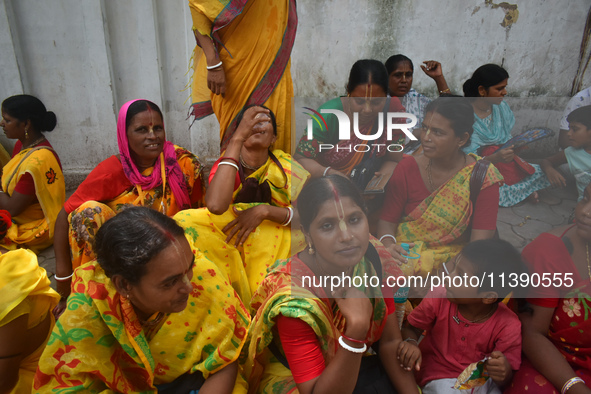 A woman is drinking water on a hot summer day in Kolkata, India, on July 7, 2024. 