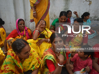 A woman is drinking water on a hot summer day in Kolkata, India, on July 7, 2024. (