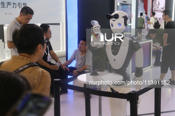 A robot is taking a person's temperature at the 2024 WAIC in Shanghai, China, on July 7, 2024. 