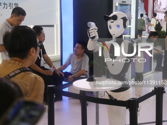 A robot is taking a person's temperature at the 2024 WAIC in Shanghai, China, on July 7, 2024. (