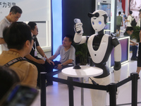 A robot is taking a person's temperature at the 2024 WAIC in Shanghai, China, on July 7, 2024. (