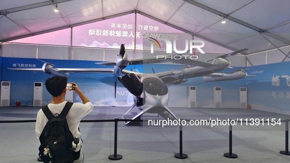 An eVTOL, a low-altitude electric vertical take-off and landing vehicle produced by AUTOFLIGHT, is being displayed at the 2024 WAIC in Shang...