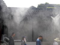 Visitors are playing in a lingering garden installed with spray in Suzhou, Jiangsu province, China, on July 8, 2024. In the hot summer, the...