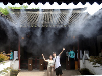 Visitors are playing in a lingering garden installed with spray in Suzhou, Jiangsu province, China, on July 8, 2024. In the hot summer, the...