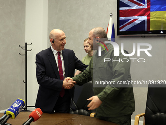 John Healey, Secretary of State for the Defence of the UK, and Rustem Umerov, Minister of Defence of Ukraine, are shaking hands before a joi...