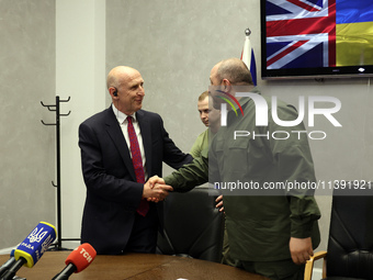 John Healey, Secretary of State for the Defence of the UK, and Rustem Umerov, Minister of Defence of Ukraine, are shaking hands before a joi...