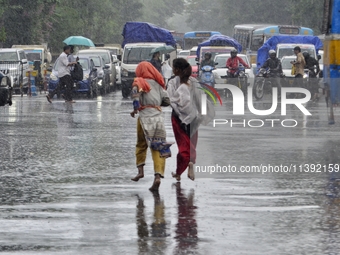 Commuters are walking past during rainfall in Kolkata, India, on July 08, 2024. (