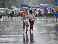 Commuters are walking past during rainfall in Kolkata, India, on July 08, 2024. (