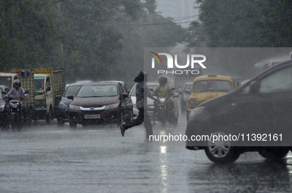 Commuters are walking past during rainfall in Kolkata, India, on July 08, 2024. 