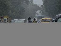 Commuters are walking past during rainfall in Kolkata, India, on July 08, 2024. (