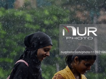 Commuters are walking past during rainfall in Kolkata, India, on July 08, 2024. (