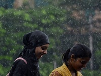 Commuters are walking past during rainfall in Kolkata, India, on July 08, 2024. (