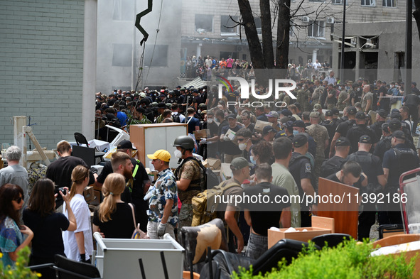 Ukrainian rescuers of emergency services and police officers are working at the site of Okhmatdyt children's hospital damaged by Russian mis...