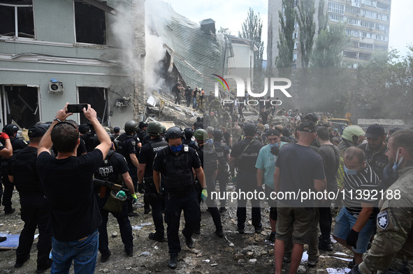 Ukrainian rescuers of emergency services and police officers are working at the site of Okhmatdyt children's hospital damaged by Russian mis...