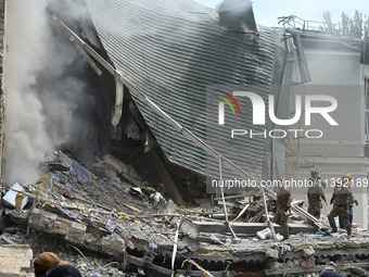 Ukrainian rescuers of emergency services and police officers are working at the site of Okhmatdyt children's hospital damaged by Russian mis...