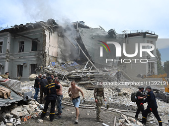 Ukrainian rescuers of emergency services and police officers are working at the site of Okhmatdyt children's hospital damaged by Russian mis...