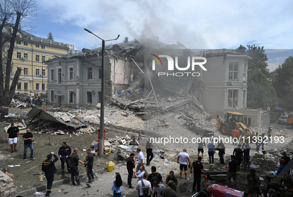 Ukrainian rescuers of emergency services and police officers are working at the site of Okhmatdyt children's hospital damaged by Russian mis...