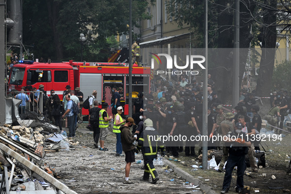 Ukrainian rescuers of emergency services and police officers are working at the site of Okhmatdyt children's hospital damaged by Russian mis...